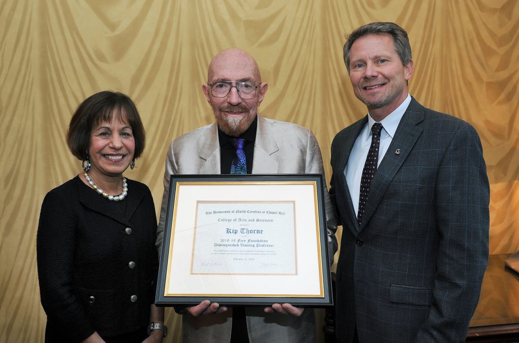Former Chancellor Carol Folt and Interim Chancellor Kevin Guskiewicz present Kip Thorne (center) with the 2018-19 Frey Foundation Distinguished Visiting Professor certificate.